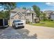 Beautiful two-story home with a two-car garage and a spacious driveway surrounded by lush greenery at 3796 Village Crossing Ln, Ellenwood, GA 30294