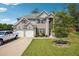 Charming two-story home with a well-manicured lawn, a spacious driveway, and a two-car garage at 3796 Village Crossing Ln, Ellenwood, GA 30294