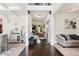 Welcoming foyer with hardwood floors leading to the dining and living rooms, showcasing an open floor plan at 3796 Village Crossing Ln, Ellenwood, GA 30294