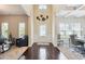 Inviting foyer with hardwood floors, decorative wall art, and views into the living and dining areas at 3796 Village Crossing Ln, Ellenwood, GA 30294