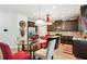 Well-lit kitchen with dark cabinetry, granite countertops, and a dining nook at 3796 Village Crossing Ln, Ellenwood, GA 30294