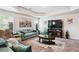 Inviting living room boasts plush seating, artwork, and a large flat-screen television at 3796 Village Crossing Ln, Ellenwood, GA 30294