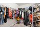 Well-organized walk-in closet features ample storage space for clothes and accessories at 3796 Village Crossing Ln, Ellenwood, GA 30294