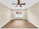 A bright bedroom includes wood floors, a ceiling fan, neutral walls, and a window at 1482 N Crossing N Cir, Atlanta, GA 30329