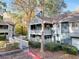 Condo exterior with beautiful curb appeal featuring lush landscaping and mature trees at 1482 N Crossing N Cir, Atlanta, GA 30329