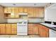 A functional kitchen boasts wooden cabinets, black countertops, and appliances at 1482 N Crossing N Cir, Atlanta, GA 30329