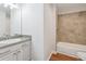 Bathroom featuring tiled shower, modern vanity, and wood-look flooring at 260 Westview Sw Pl, Atlanta, GA 30314