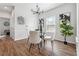 Dining room featuring a glass-top table, four chairs, modern chandelier and hardwood floors at 260 Westview Sw Pl, Atlanta, GA 30314