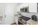 Modern kitchen features stainless steel appliances, granite counters, and white cabinets at 260 Westview Sw Pl, Atlanta, GA 30314