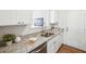 Bright kitchen features granite countertops, stainless steel appliances, and white cabinets at 260 Westview Sw Pl, Atlanta, GA 30314