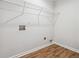Practical laundry area featuring wire shelving and wood-look flooring for easy maintenance at 260 Westview Sw Pl, Atlanta, GA 30314