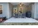 View of outdoor patio with chairs, small table, grill, and fenced-in backyard with lots of trees at 263 Jefferson Ave, Canton, GA 30114