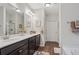 Bathroom with double sink vanity, framed mirrors, shower and tub at 263 Jefferson Ave, Canton, GA 30114