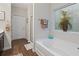 Bright bathroom featuring a soaking tub with decorative glass block window at 263 Jefferson Ave, Canton, GA 30114