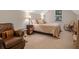 Comfortable bedroom features a cozy chair, bedside table with lamp, and a plush, inviting bed at 263 Jefferson Ave, Canton, GA 30114