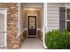 Inviting entryway with stylish front door, stone accents, and neutral siding, creating a warm welcome at 263 Jefferson Ave, Canton, GA 30114
