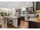 Modern kitchen featuring dark wood cabinets, granite countertops, and stainless steel appliances, perfect for cooking at 263 Jefferson Ave, Canton, GA 30114