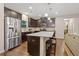 Well-lit kitchen with stainless steel appliances, dark cabinets, granite countertops, and an island with bar stool seating at 263 Jefferson Ave, Canton, GA 30114