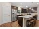 Modern kitchen features stainless steel appliances, dark wood cabinets, and a center island with granite countertops and seating at 263 Jefferson Ave, Canton, GA 30114