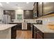 Well-equipped kitchen with dark wood cabinets, granite counters, and stainless appliances, great for entertaining at 263 Jefferson Ave, Canton, GA 30114
