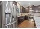 Updated kitchen featuring stainless steel appliances, dark wood cabinets, granite countertops, and hardwood flooring at 263 Jefferson Ave, Canton, GA 30114