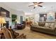Comfortable living room with a fireplace, sofa, and armchairs, seamlessly connected to the adjacent dining and kitchen areas at 263 Jefferson Ave, Canton, GA 30114