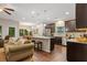 Open-concept living space with hardwood floors, a cozy sofa, and a view into the modern kitchen at 263 Jefferson Ave, Canton, GA 30114