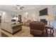 Bright living room with a fireplace, comfortable seating, and a ceiling fan, creating a welcoming atmosphere at 263 Jefferson Ave, Canton, GA 30114