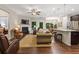 Spacious living room with a fireplace, comfortable seating, and an open layout connecting to the dining area and kitchen at 263 Jefferson Ave, Canton, GA 30114