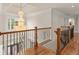 Grand foyer features a crystal chandelier, wood floors, and decorative iron railing at 2832 Springbluff Ln, Buford, GA 30519