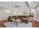 Spacious living room with wood floors, neutral walls, and a comfortable sectional sofa at 2832 Springbluff Ln, Buford, GA 30519