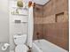 Bathroom featuring a white bathtub with brown tile surround and decorative shelves at 1 Biscayne Nw Dr # 112, Atlanta, GA 30309