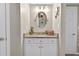 Bathroom featuring granite countertop, oval mirror, and white cabinets at 1 Biscayne Nw Dr # 112, Atlanta, GA 30309