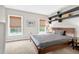 Bedroom with large bed, shelving, and windows with woven shades at 1 Biscayne Nw Dr # 112, Atlanta, GA 30309