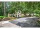 Community entrance features a sign, lush landscaping, and parking for visitors at 1 Biscayne Nw Dr # 112, Atlanta, GA 30309