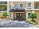 Building entrance with an awning, manicured landscaping, and easy access for residents at 1 Biscayne Nw Dr # 112, Atlanta, GA 30309