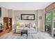 Comfortable living room with a love seat, side table, artful decor and sliding doors to the balcony at 1 Biscayne Nw Dr # 112, Atlanta, GA 30309