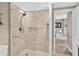 Elegant bathroom shower with tiled walls, recessed niche, and glass door at 1 Biscayne Nw Dr # 112, Atlanta, GA 30309