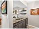 Modern wet bar features granite countertops and stylish gray cabinets at 1 Biscayne Nw Dr # 112, Atlanta, GA 30309