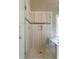 Glass enclosed shower in a tiled bathroom with shower niche and rain shower head at 1254 Hadaway Garden Nw Dr, Kennesaw, GA 30152