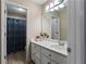 White cabinets in this bathroom create a clean aesthetic along with decorative wall lighting at 1254 Hadaway Garden Nw Dr, Kennesaw, GA 30152