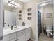Clean bathroom with white cabinets, a sink, a mirror, and decorated with funny signs at 1254 Hadaway Garden Nw Dr, Kennesaw, GA 30152