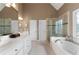 Bathroom with dual sinks, a soaking tub, and a glass shower with designer tile at 1254 Hadaway Garden Nw Dr, Kennesaw, GA 30152