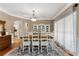 Elegant dining room featuring hardwood floors, decorative light fixture, and bright window at 1254 Hadaway Garden Nw Dr, Kennesaw, GA 30152