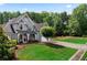 Charming grey brick home on a lush green lawn with mature trees and an inviting driveway at 1254 Hadaway Garden Nw Dr, Kennesaw, GA 30152
