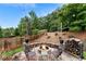 Stone patio features a cozy fire pit with seating, perfect for outdoor gatherings under string lights at 1254 Hadaway Garden Nw Dr, Kennesaw, GA 30152