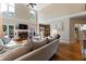 Inviting living room with hardwood flooring, fireplace, and backyard views, adjacent to the kitchen at 1254 Hadaway Garden Nw Dr, Kennesaw, GA 30152