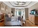 Well-appointed main bedroom with natural light, a ceiling fan, and a cozy seating area at 1254 Hadaway Garden Nw Dr, Kennesaw, GA 30152