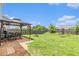 Spacious backyard features a patio, pergola, well-maintained lawn, and play equipment for outdoor fun at 3350 Clawing Hawk Way, Douglasville, GA 30135
