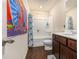 Compact bathroom featuring a themed shower curtain, toilet, and vanity with storage at 3350 Clawing Hawk Way, Douglasville, GA 30135